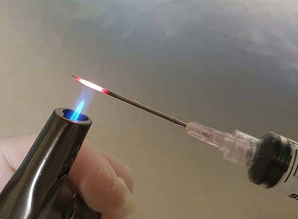 Flame sterilising the syringe